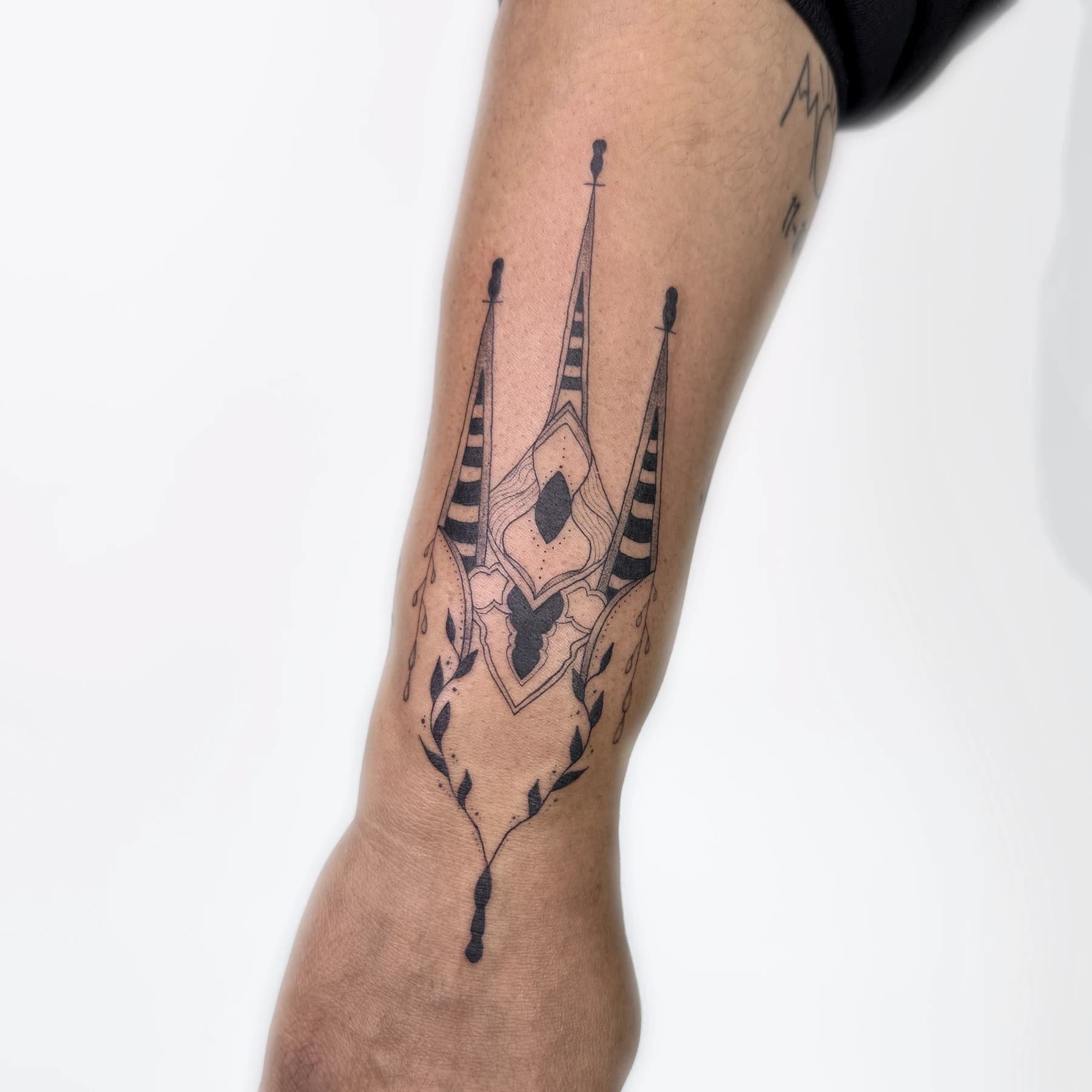 Fine line gothic cathedral sigil tattoo on the forearm by Nika Osseili.