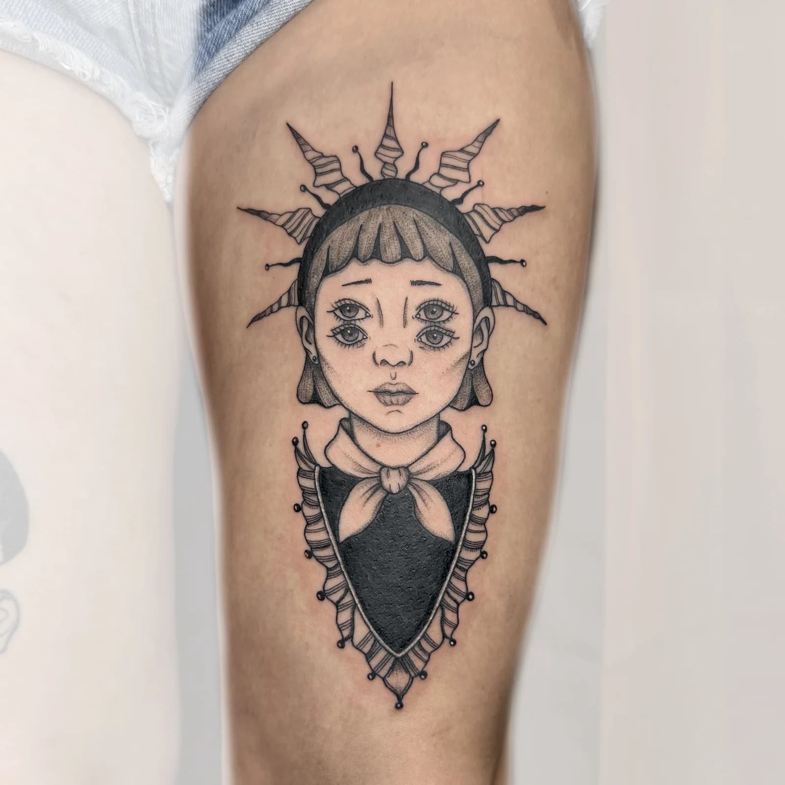 Stylized portrait tattoo with ornamental details by Nika Osseili.