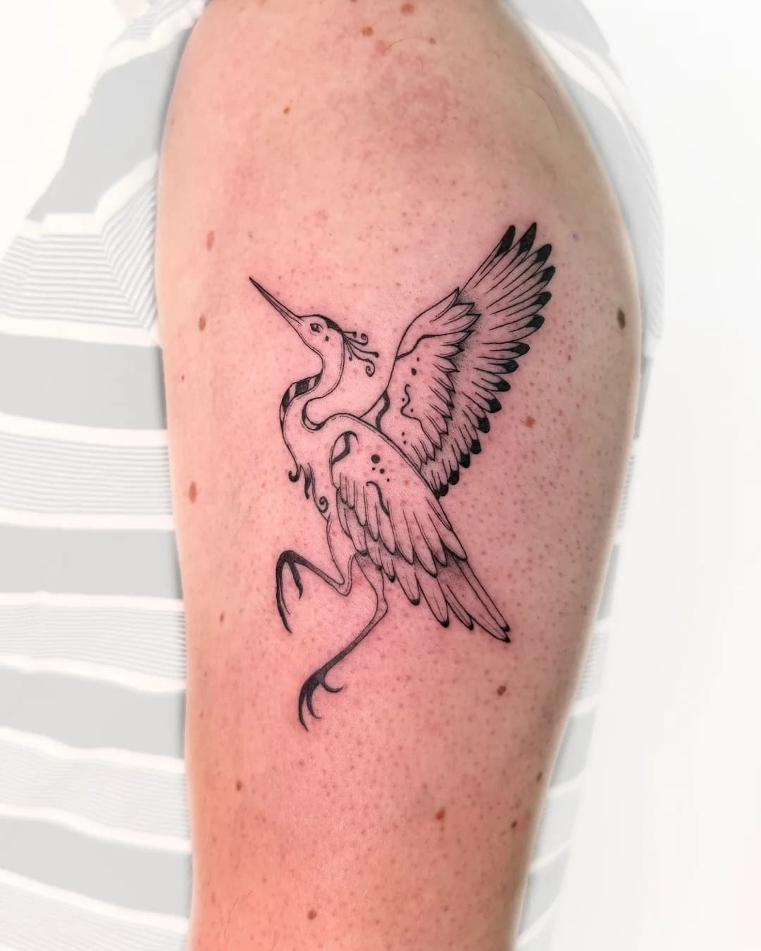 Fine line ornamental crane tattoo by Nika Osseili.