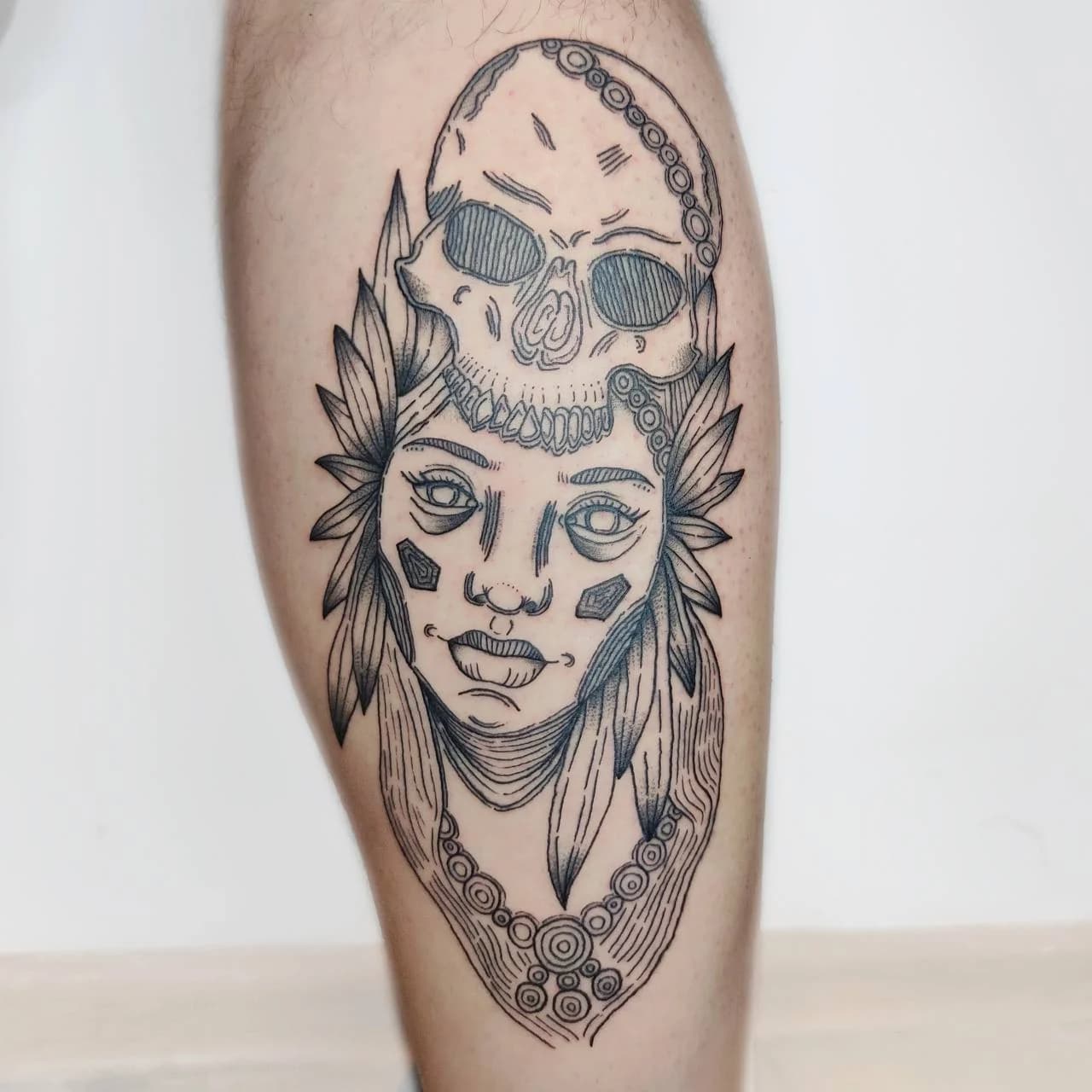 Surreal portrait tattoo with skull and ornamental details by Nika Osseili.